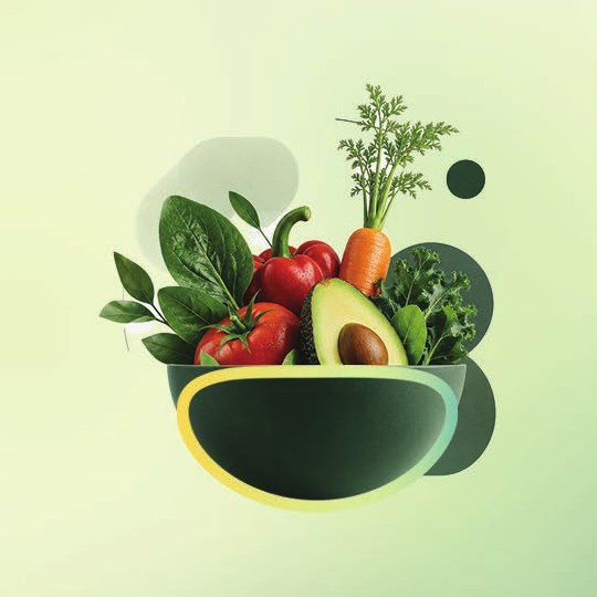 A bowl of fresh vegetables including avocado, tomato, pepper, carrot and leafy greens
